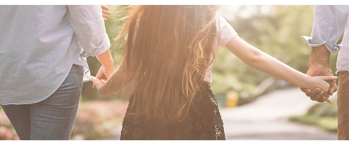 Happy family mother father and daughter walk on nature on sunset hold hand
